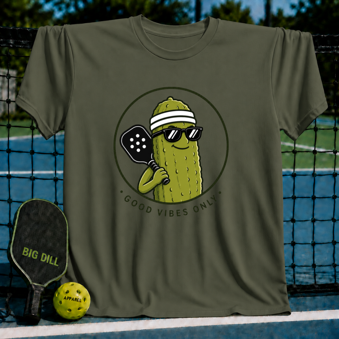 Olive green unisex t-shirt featuring a smiling pickle character in sunglasses and a visor holding a pickleball paddle.