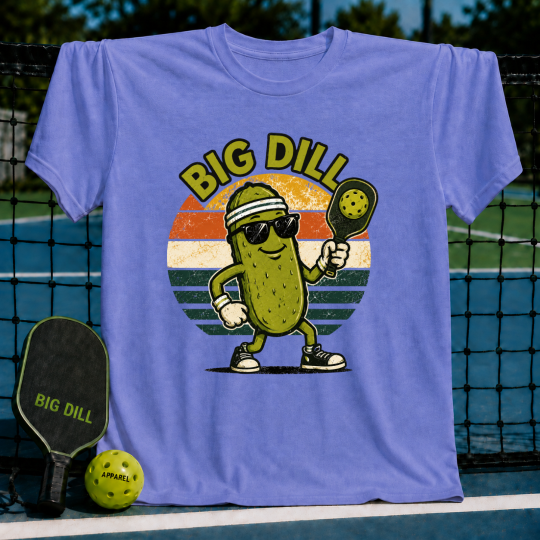Light blue unisex t-shirt featuring a retro pickleball-playing pickle graphic in a sunset circle on a pickleball court.