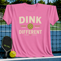Pink Dink Different pickleball t-shirt with a distressed vintage graphic of a green ball on a pickleball court background.