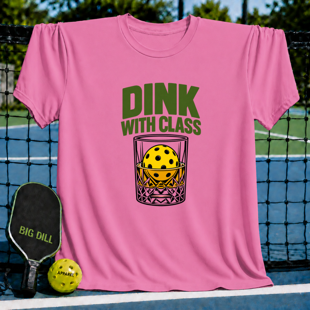 Pink crewneck t-shirt featuring a Dink With Class graphic of a pickleball in a whiskey glass, displayed on a court.