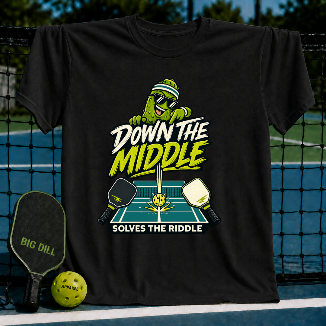 Black cotton T-shirt featuring a pickleball-themed graphic of a pickle character, paddles, and the text Down the Middle.
