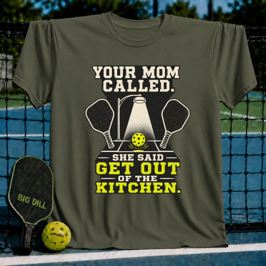 Olive green unisex t-shirt featuring a pickleball graphic with two paddles, a spotlight, and the text Your Mom Called.