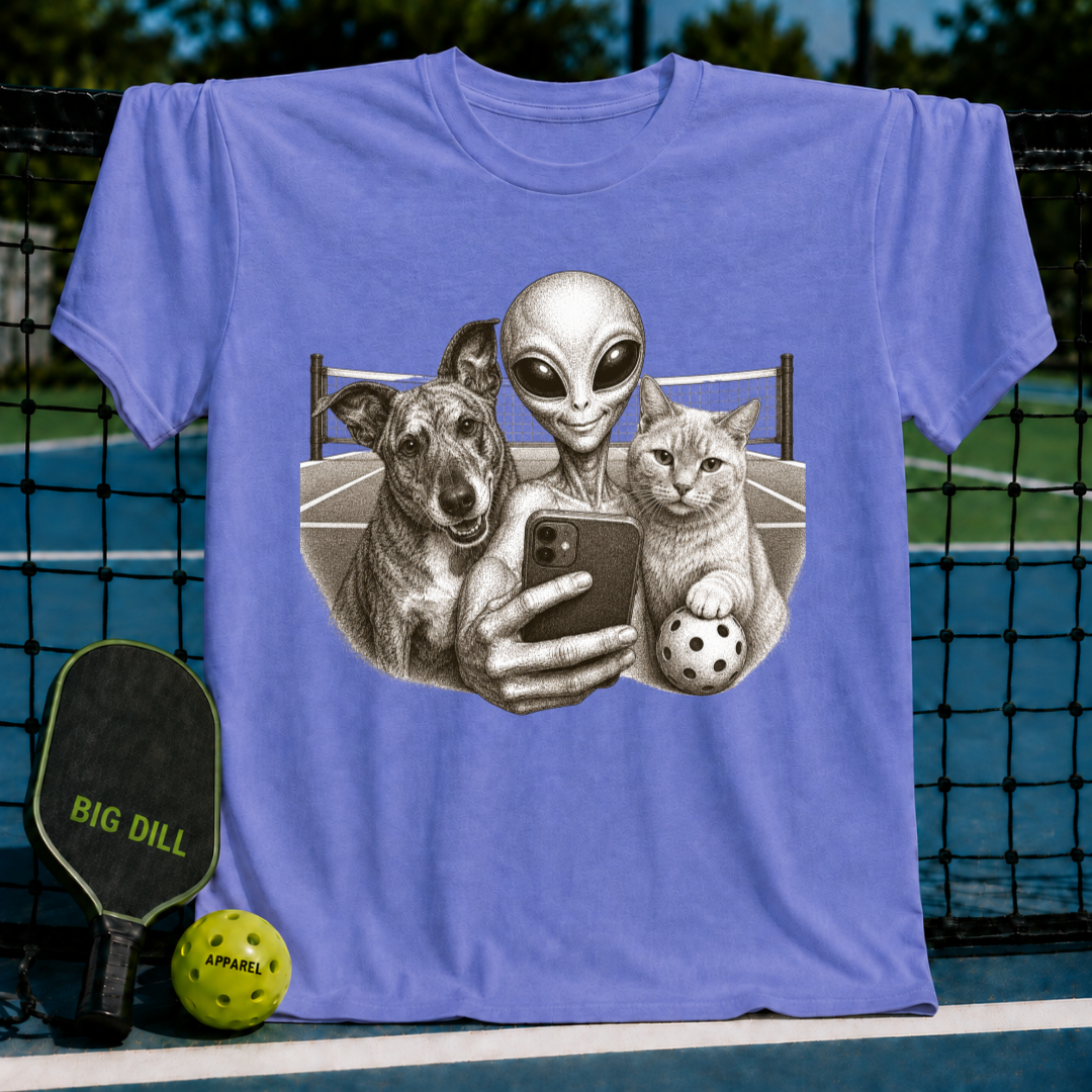 Light purple unisex t-shirt featuring a vintage illustration of an alien, dog, and cat taking a selfie on a pickleball court.