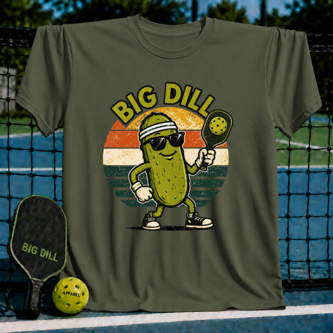 Olive green unisex t-shirt featuring a retro pickleball-playing pickle graphic with sunglasses and a paddle.