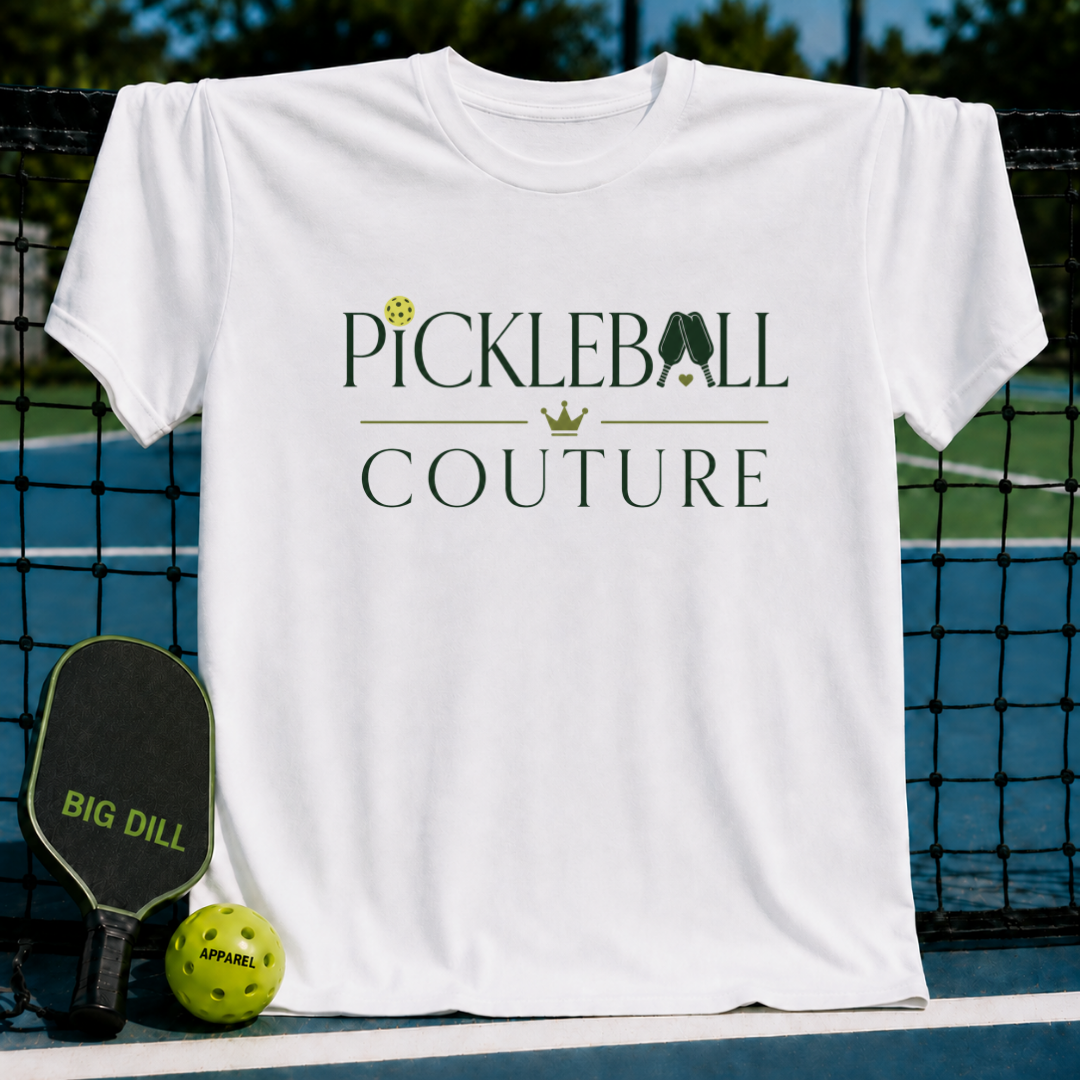 White unisex t-shirt featuring dark green Pickleball Couture text, a gold crown, and pickleball paddle graphic.