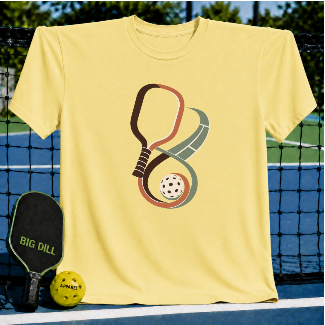 Light yellow crew neck t-shirt featuring an infinity-shaped pickleball paddle and court graphic with a ball.