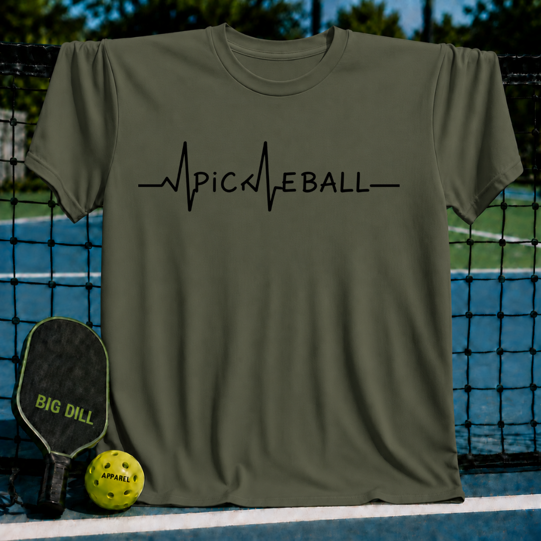 Olive green unisex t-shirt featuring a black EKG heartbeat line graphic that spells out Pickleball on a pickleball court.