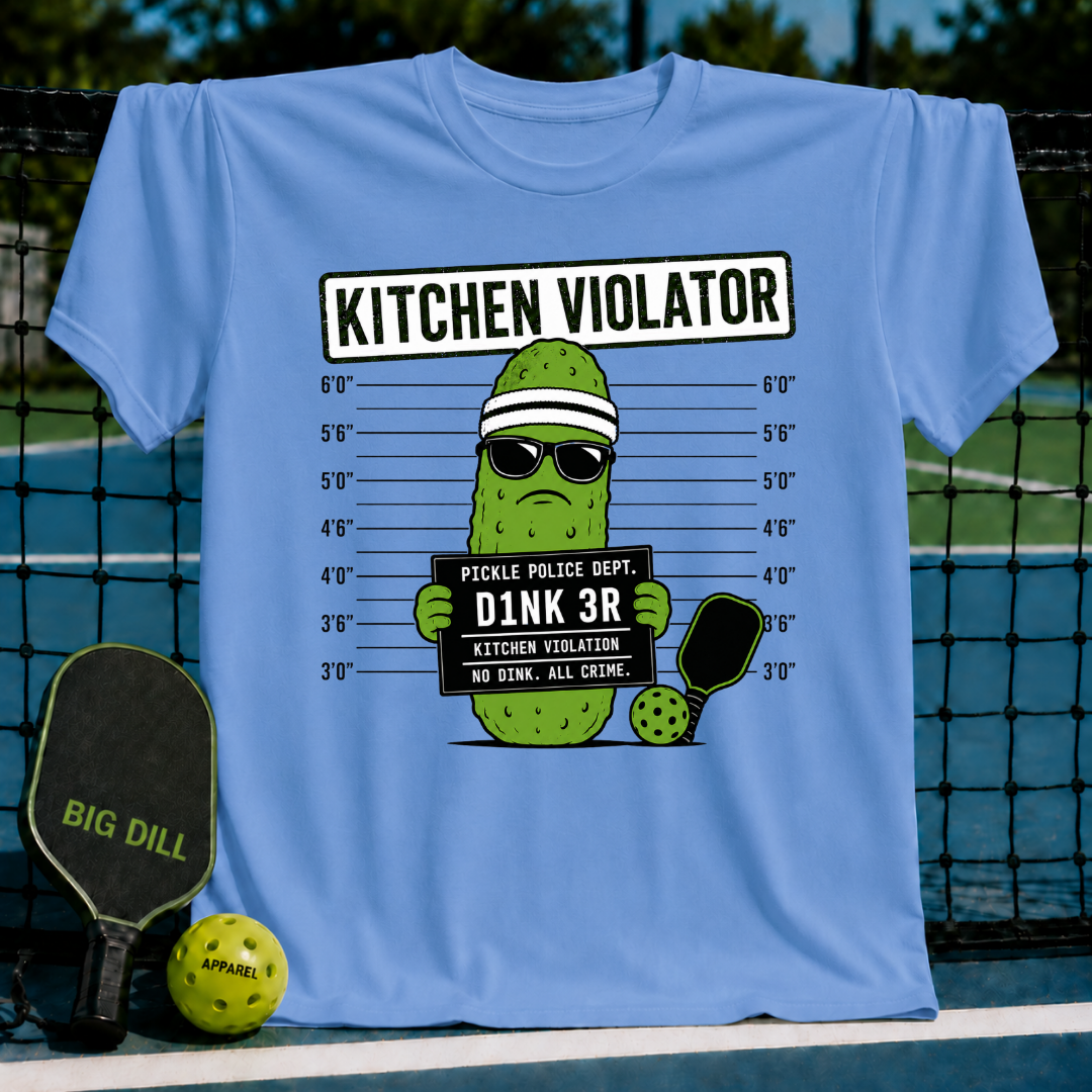 Light blue t-shirt featuring a pickle mug shot graphic with sunglasses, a headband, and a pickleball paddle on a court.
