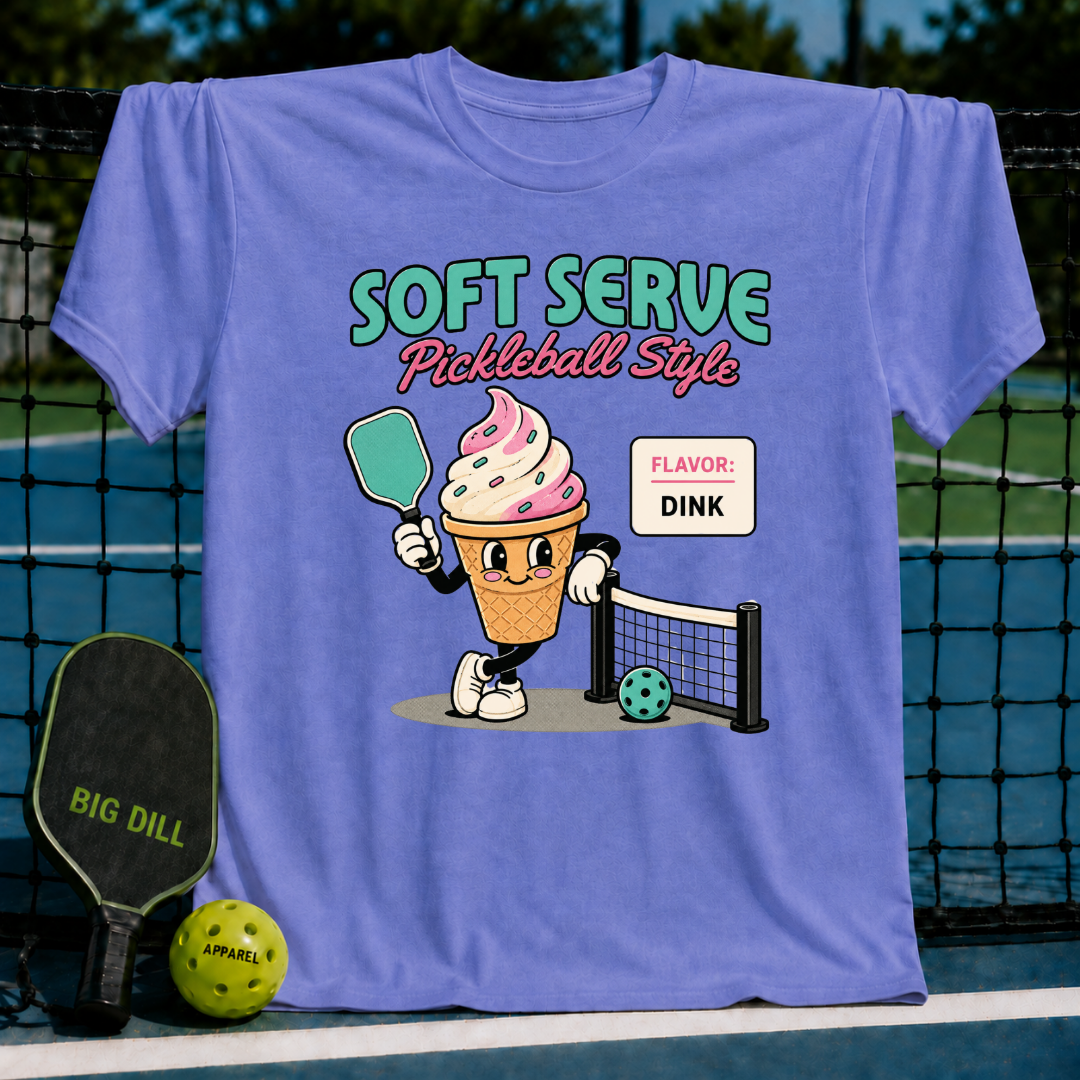 Periwinkle unisex t-shirt featuring a retro ice cream cone character holding a pickleball paddle on a court background.