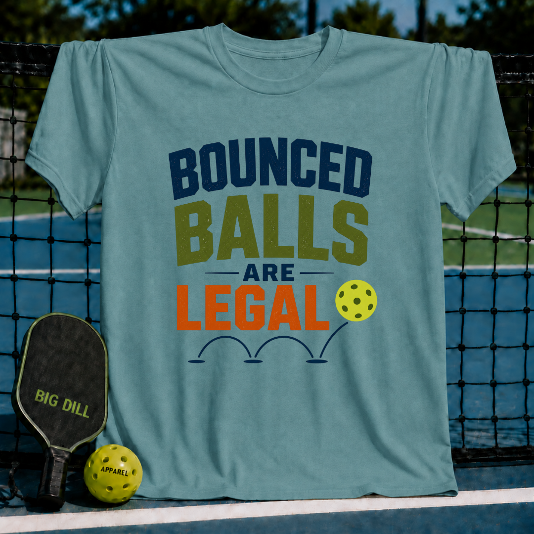 Periwinkle unisex t-shirt featuring Bounced Balls Are Legal text, pickleball graphic, and court background.