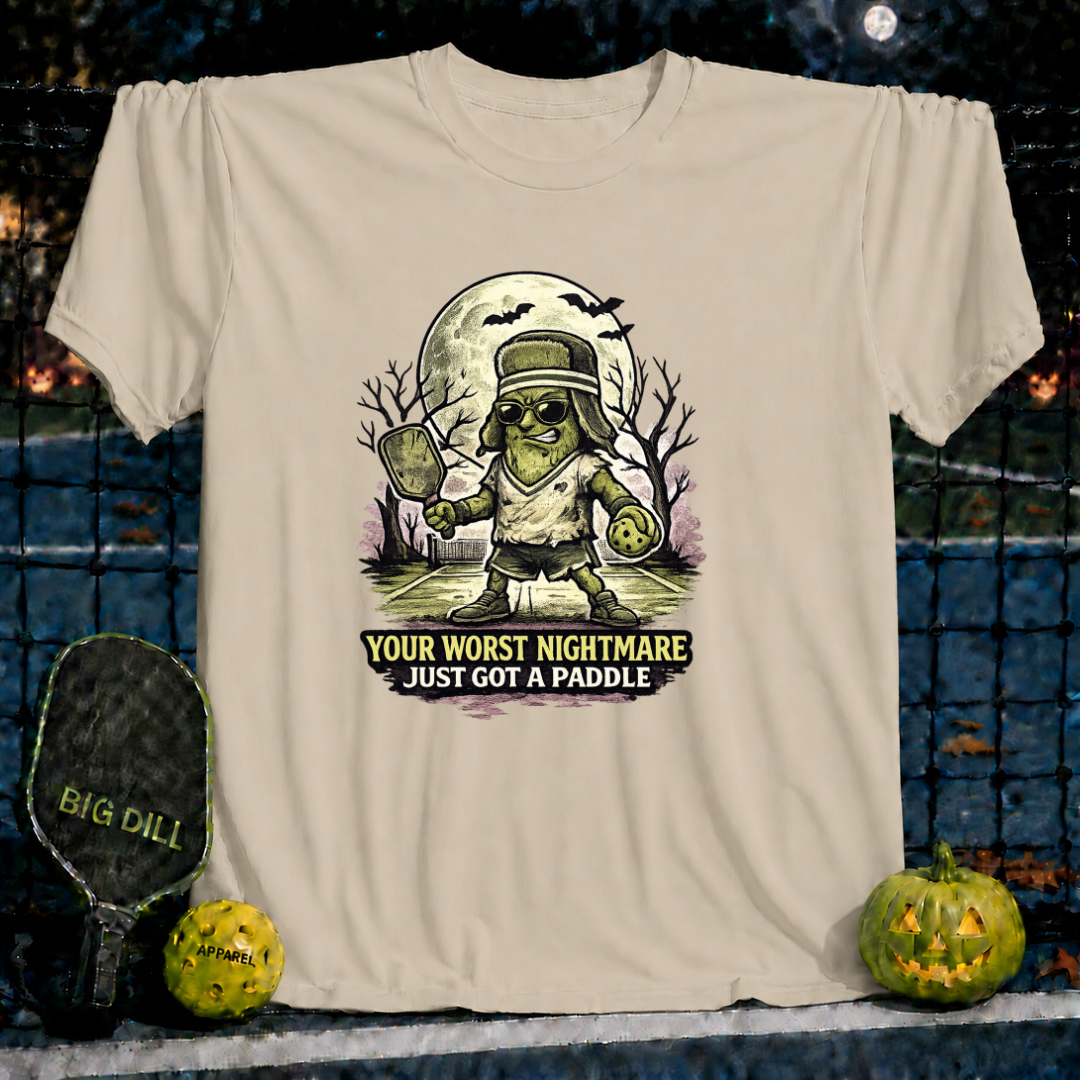 Sand-colored unisex t-shirt featuring a Frankenstein pickleball player graphic with the text Your Worst Nightmare Just Got A Paddle.