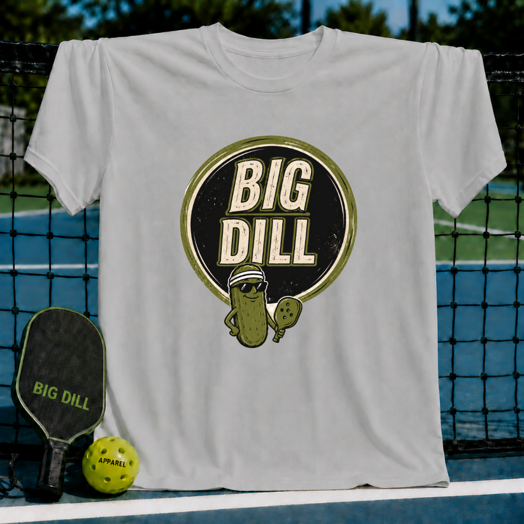 Light gray crew neck t-shirt featuring a Big Dill pickle graphic with sunglasses and a pickleball paddle.