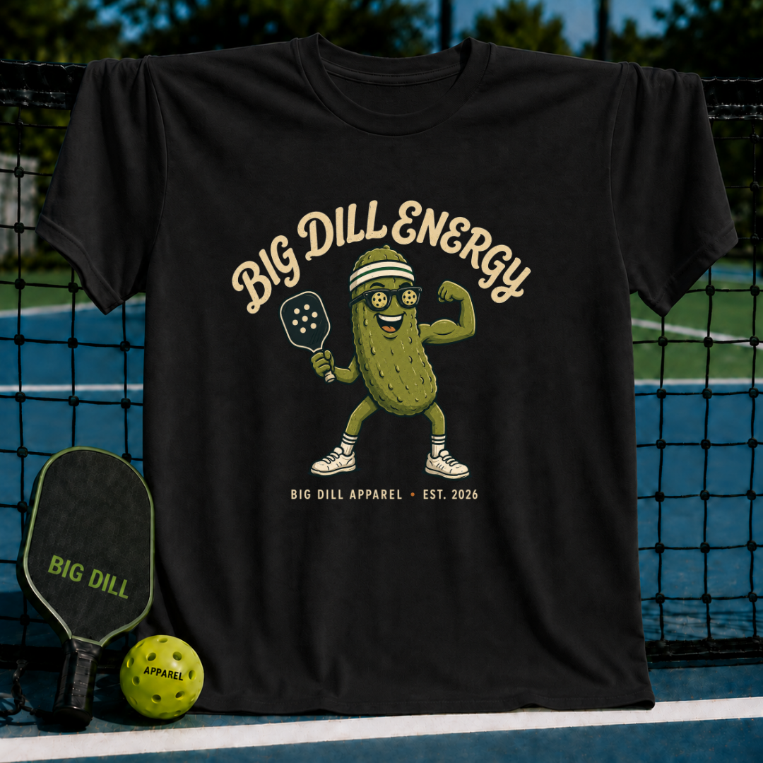 Black unisex t-shirt featuring a pickleball-playing pickle mascot with Big Dill Energy text on a pickleball court.