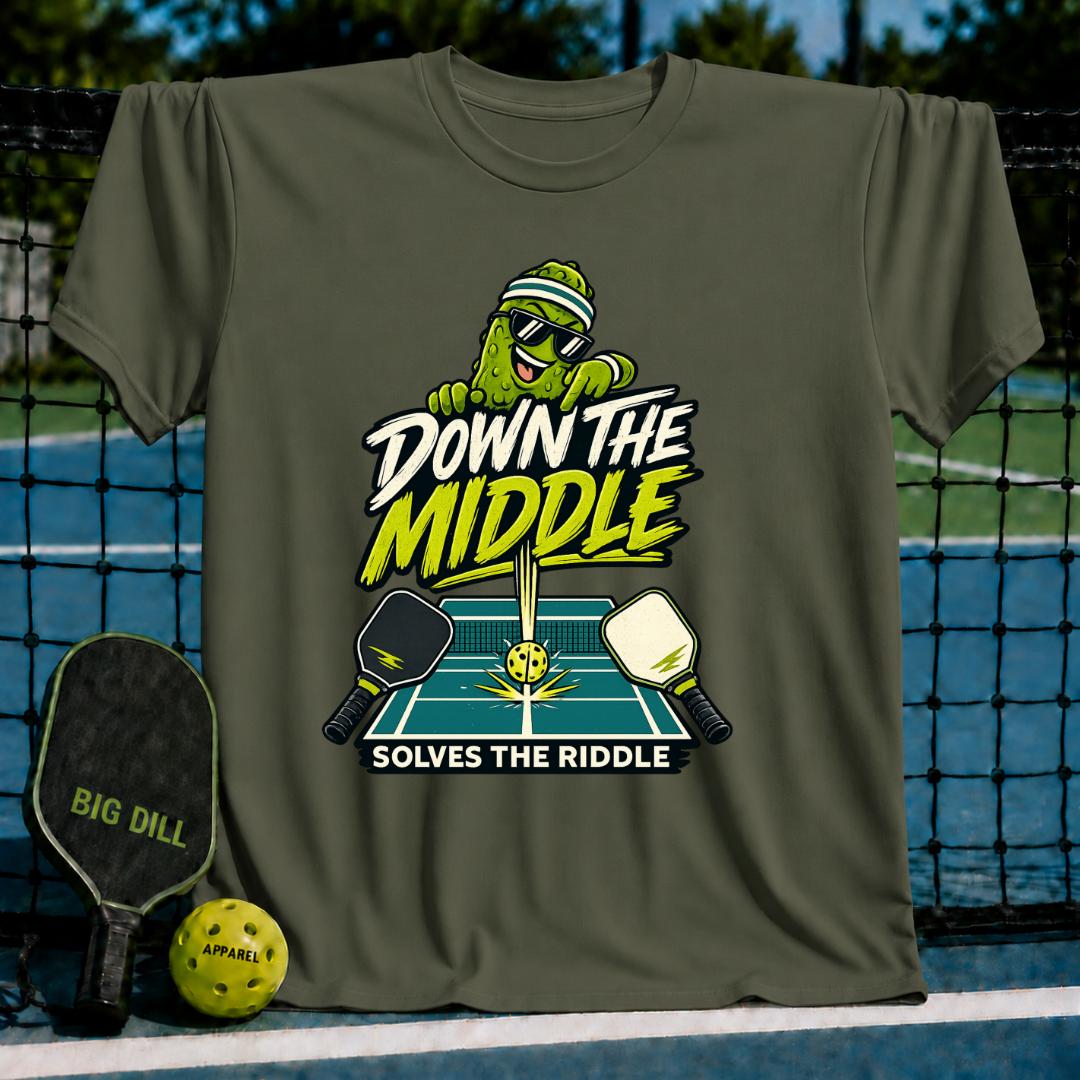 Olive green crew neck t-shirt featuring a pickleball-themed graphic with a cartoon pickle, paddles, and court design.