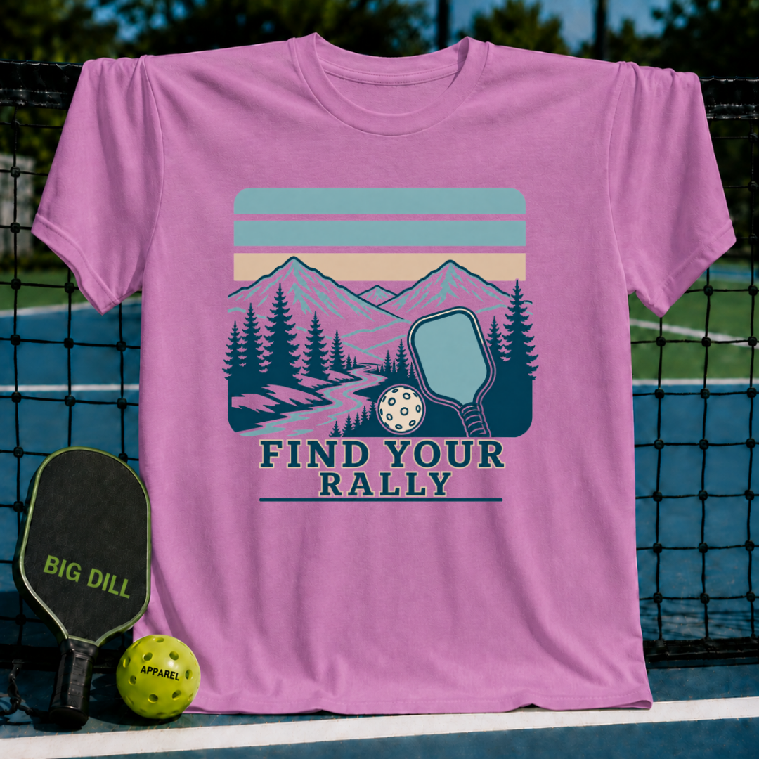 Pink cotton t-shirt featuring a retro mountain landscape, pickleball paddle, and Find Your Rally text graphic.