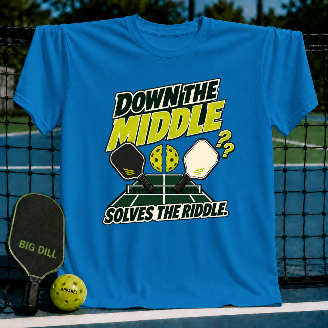 Bright blue crew neck T-shirt featuring a pickleball graphic with paddles, a ball, and the text Down the Middle Solves the Riddle.