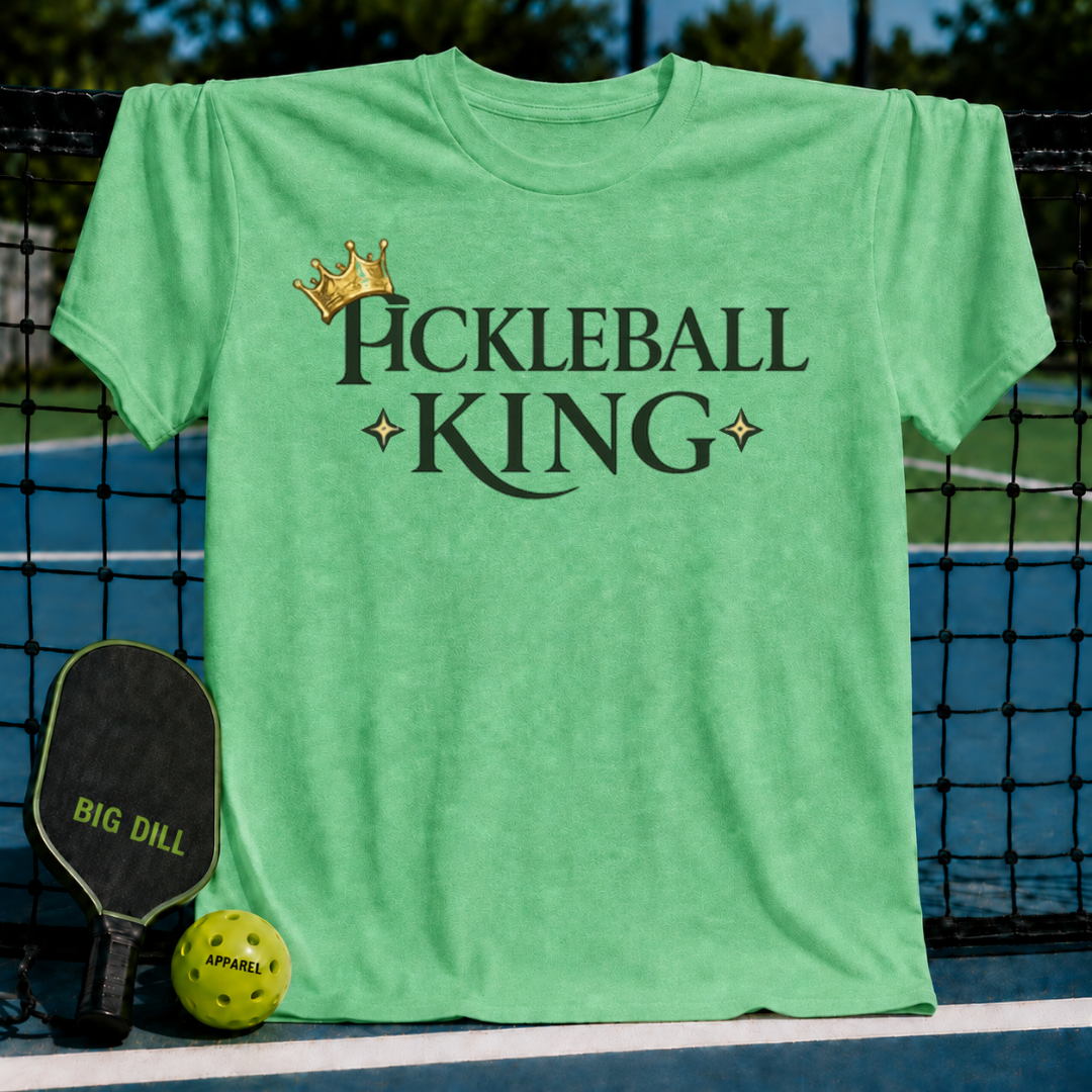 Light green unisex t-shirt featuring a dark olive Pickleball King logo with a gold crown and star accents on a court.