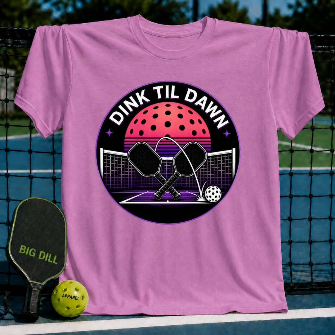 Pink unisex t-shirt featuring a retro-synthwave pickleball graphic with crossed paddles and a neon moon design.
