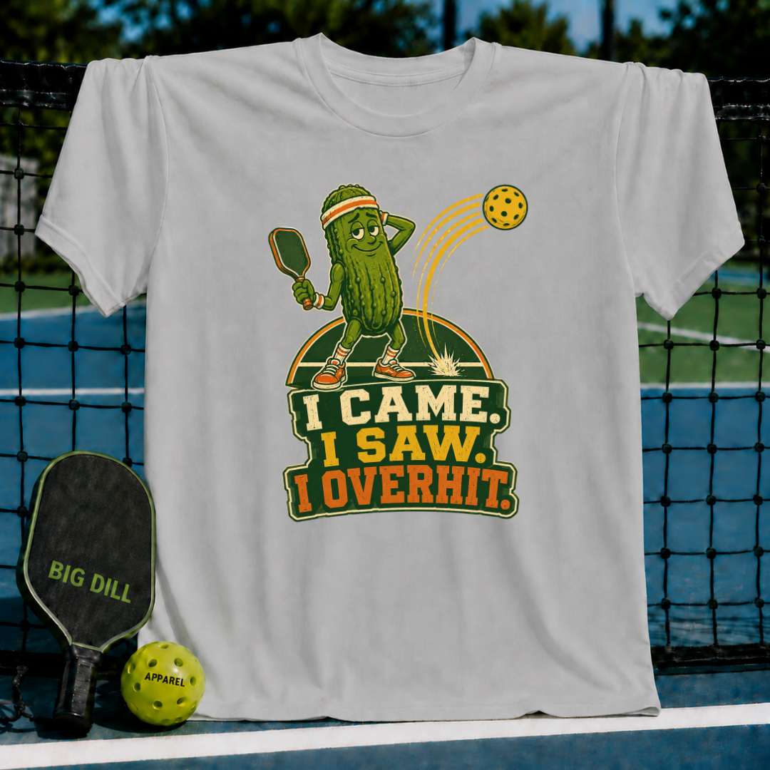 Light gray Overhitter t-shirt featuring a cartoon pickle playing pickleball with the text I Came, I Saw, I Overhit.