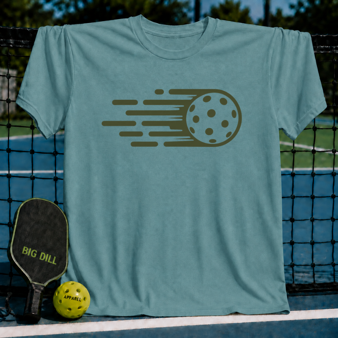 Blue-grey Hyper Dink unisex t-shirt featuring a dark green motion-line pickleball graphic, displayed on a pickleball court.