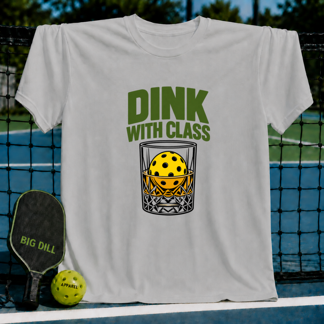Light gray crew neck t-shirt featuring a pickleball in a glass graphic with the text Dink With Class in green.