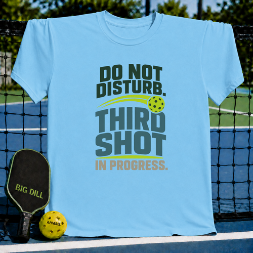Light blue crew neck t-shirt featuring a green and yellow pickleball-themed Do Not Disturb Third Shot graphic design.