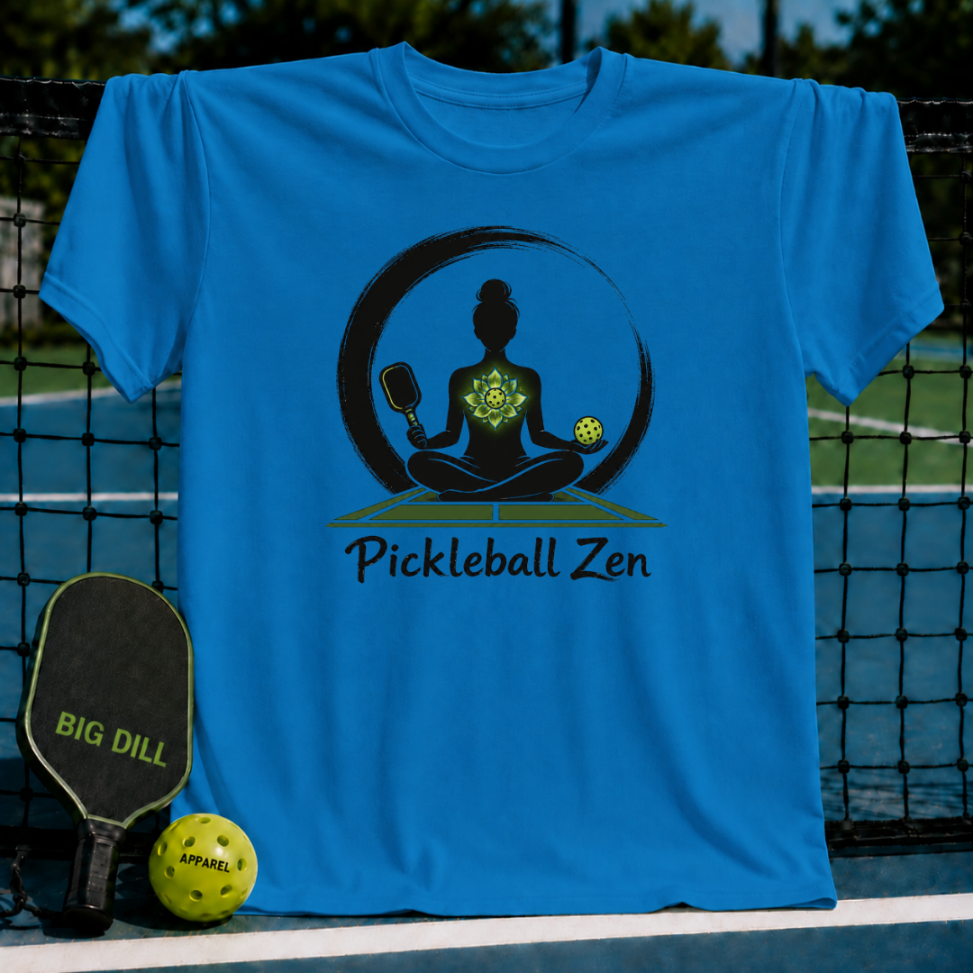 Bright blue crewneck t-shirt featuring a Zen meditation graphic with a pickleball paddle and ball on a court background.