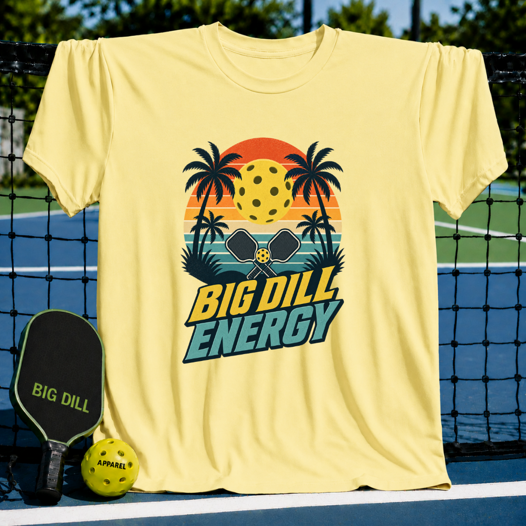 Light yellow crewneck t-shirt featuring a retro sunset, palm trees, and pickleball graphic with Big Dill Energy text.