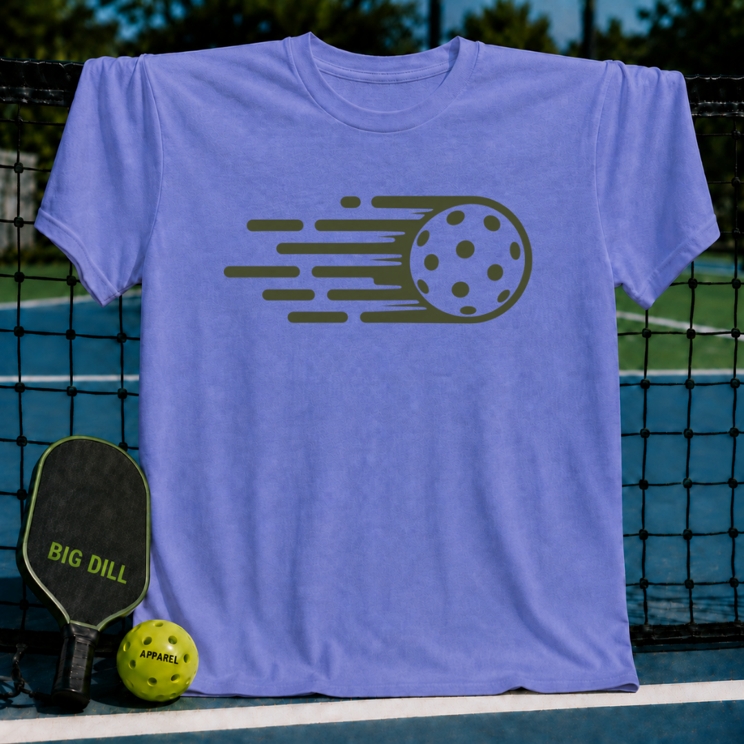 Periwinkle blue unisex t-shirt featuring a dark green graphic of a pickleball with motion lines, displayed on a court net.