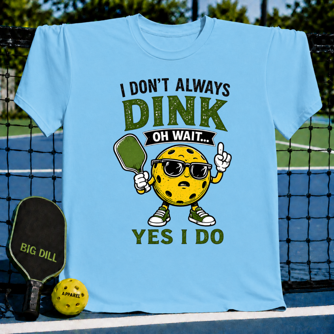 Light blue crew neck t-shirt featuring a cartoon pickleball character with sunglasses and the text I Don't Always Dink.
