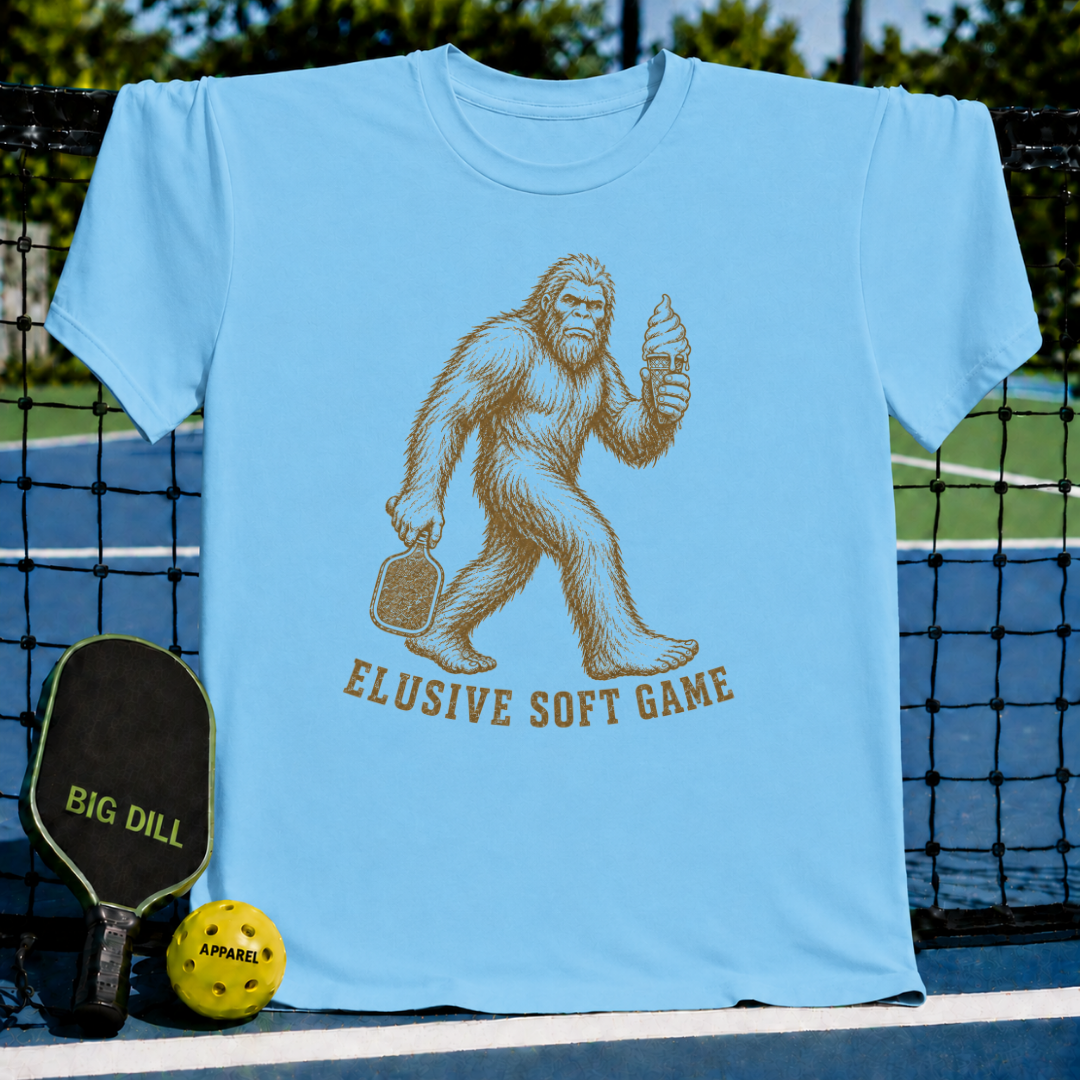 Sky blue unisex t-shirt featuring a vintage Sasquatch graphic holding a pickleball paddle and a melting ice cream cone.