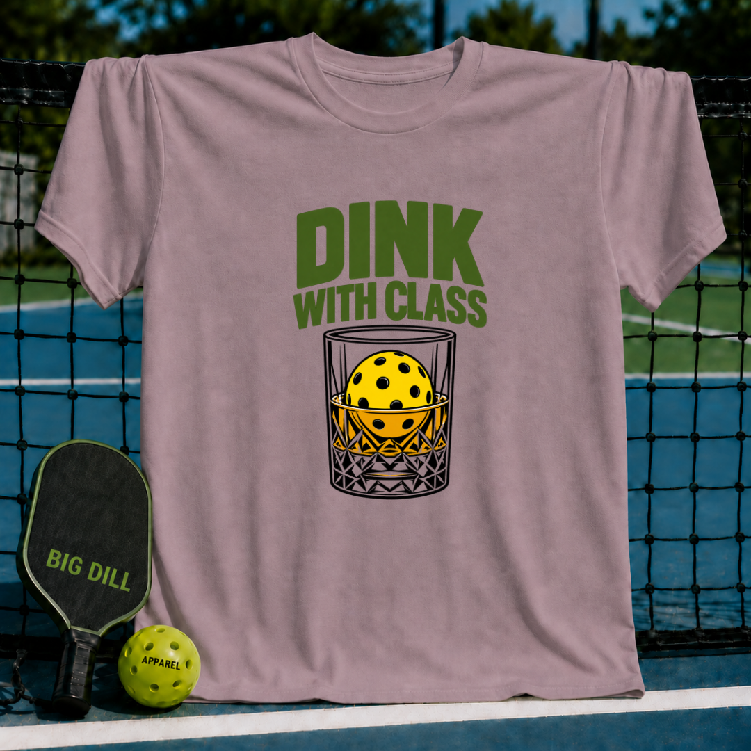 Mauve crewneck t-shirt featuring a pickleball in a glass graphic with the text Dink With Class on a pickleball court.