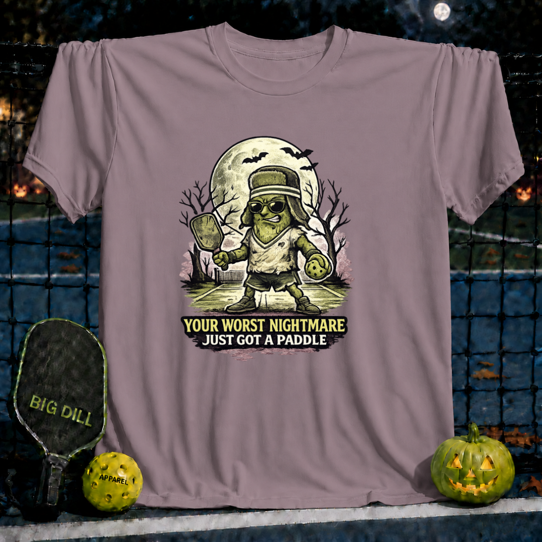 Mauve unisex t-shirt featuring a Frankenstein-style pickleball player graphic with the text Your Worst Nightmare Just Got A Paddle.