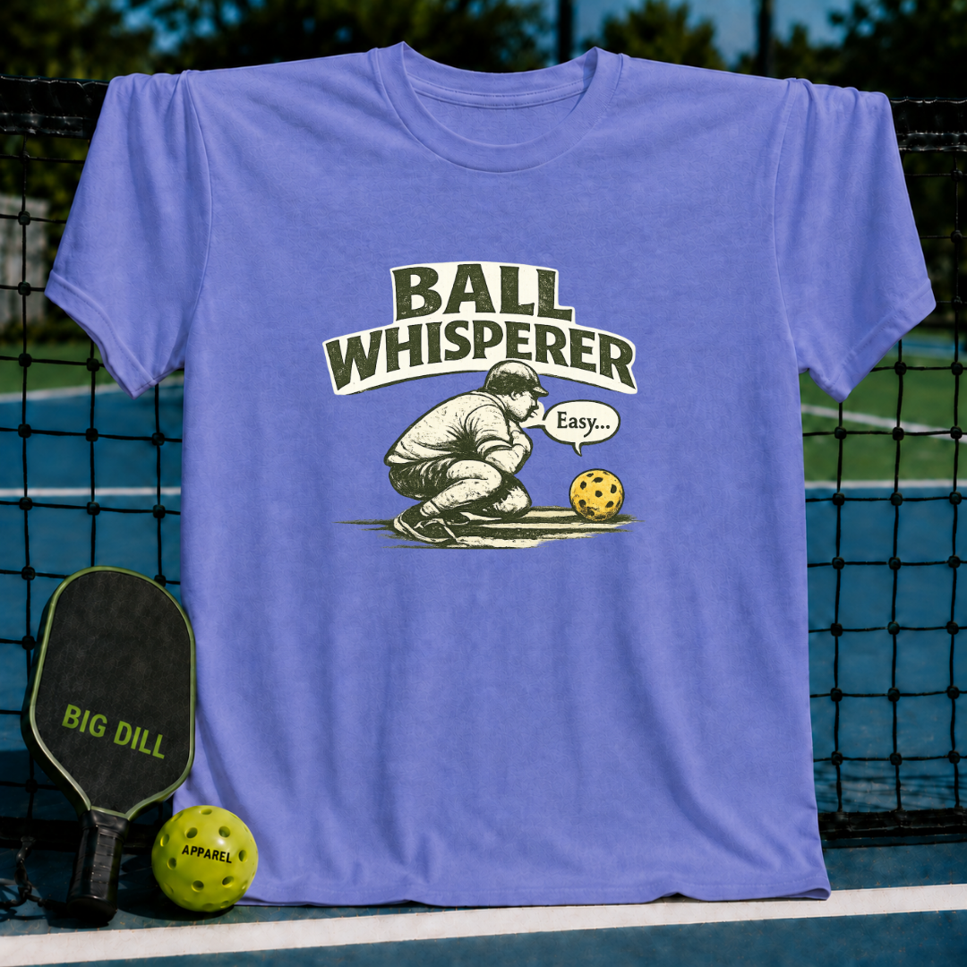 Periwinkle blue unisex t-shirt featuring a vintage illustration of a player whispering to a pickleball.