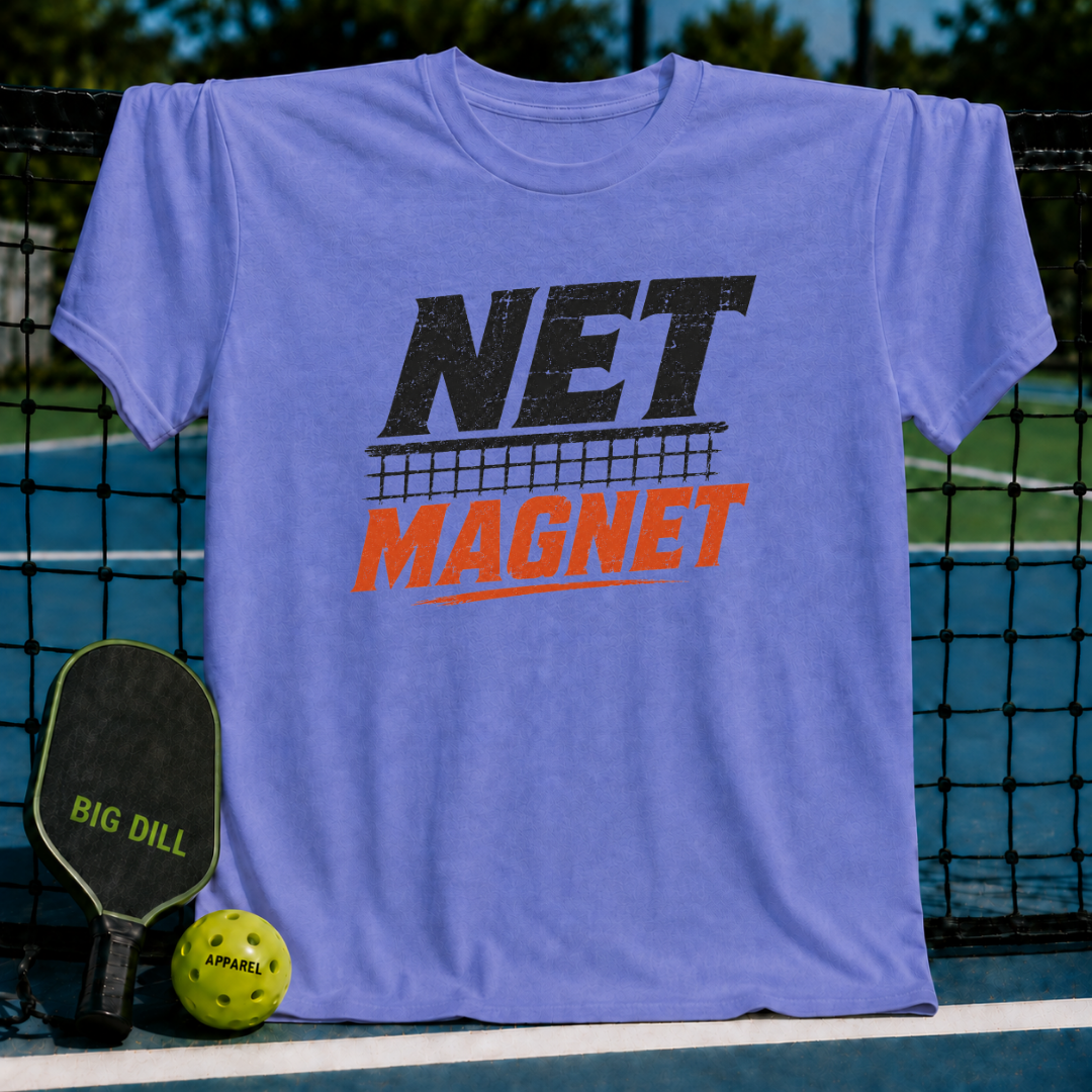 Vibrant blue unisex tee with distressed black and orange Net Magnet graphic, displayed on a pickleball court.