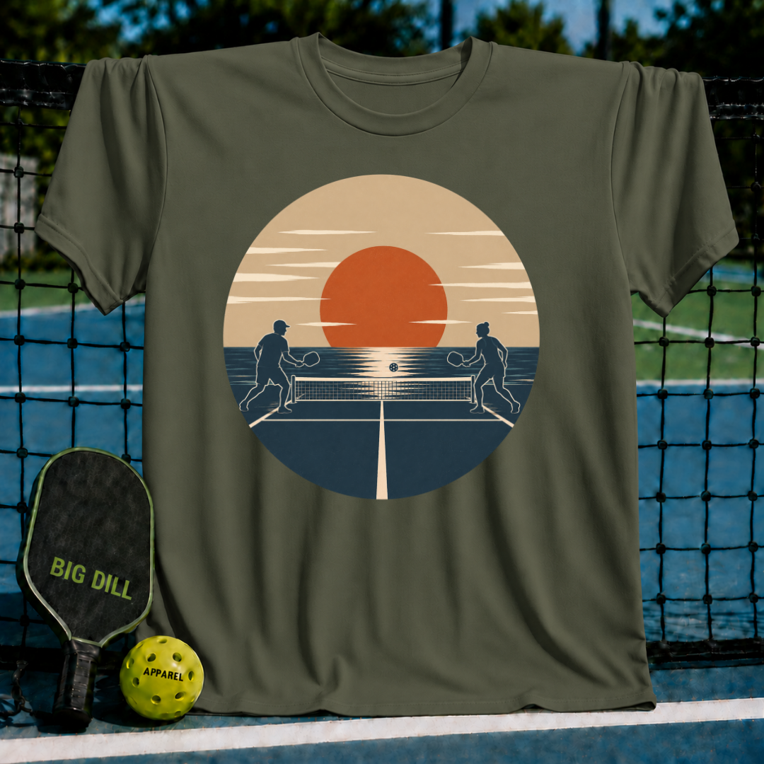 Military olive green unisex t-shirt featuring a retro sunset pickleball court graphic with two player silhouettes.