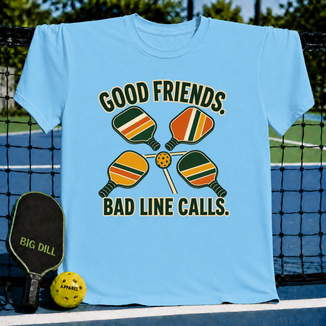 Light blue crewneck t-shirt featuring a retro pickleball graphic with four paddles and a ball, displayed on a court.