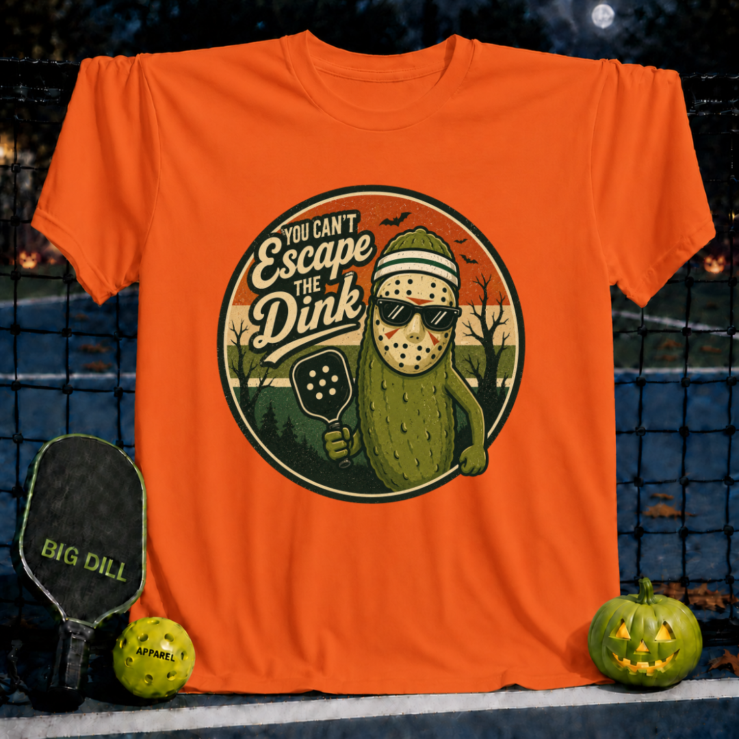Orange unisex t-shirt featuring a spooky pickleball-playing pickle wearing a hockey mask and sunglasses.