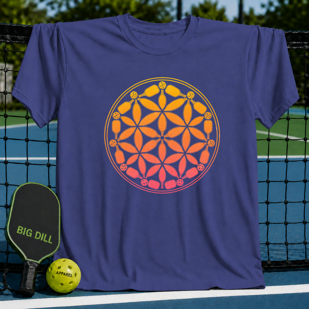 Purple t-shirt featuring a vibrant orange and yellow Flower of Life design made of pickleball paddles and balls.
