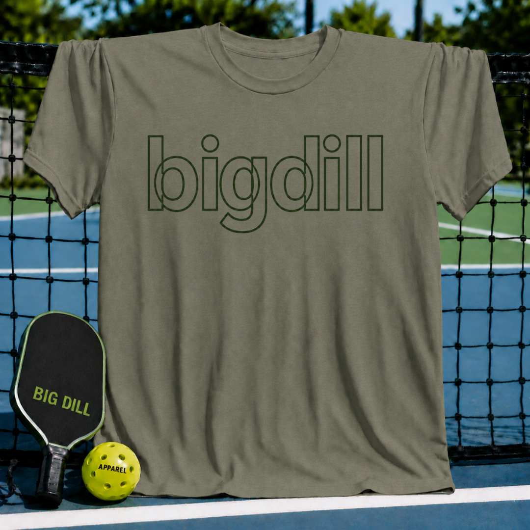 Olive green unisex t-shirt with Big Dill outline lettering, displayed on a pickleball court with a paddle and ball.