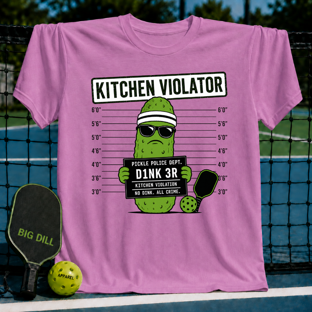 Pink crewneck T-shirt featuring a pickle character in sunglasses and a headband holding a mug shot sign on a court.