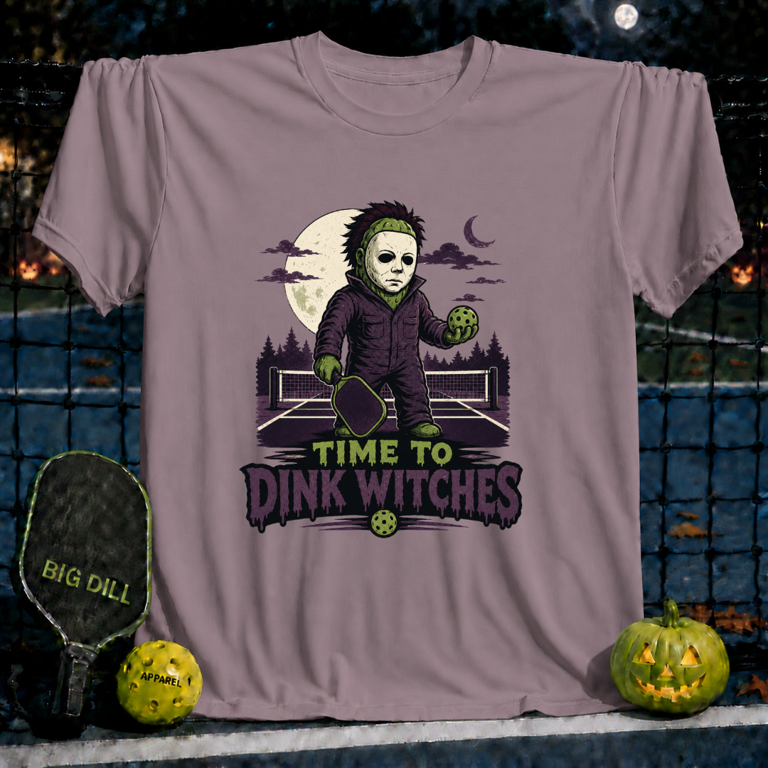 Mauve unisex pickleball t-shirt featuring a spooky masked character holding a paddle and ball with Time to Dink Witches text.