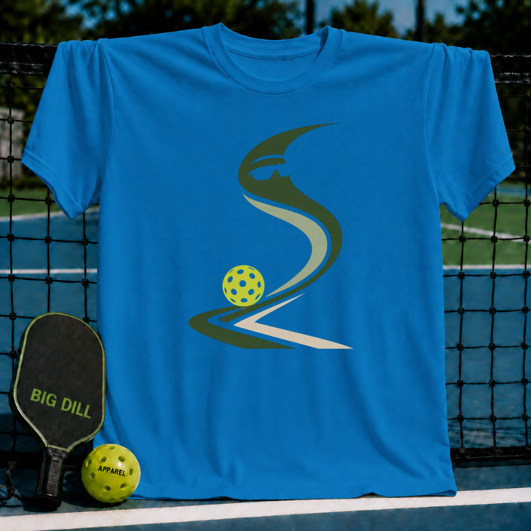Bright blue crewneck t-shirt featuring a stylized pickleball graphic, displayed on a pickleball court net.