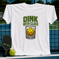 White crewneck t-shirt featuring a Dink With Class graphic of a pickleball in a whiskey glass, displayed on a court.