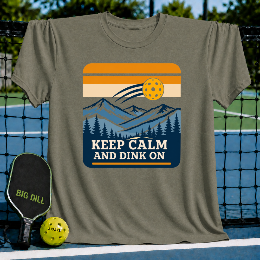 Olive green crewneck t-shirt featuring a retro mountain landscape graphic with a pickleball and Keep Calm And Dink On text.