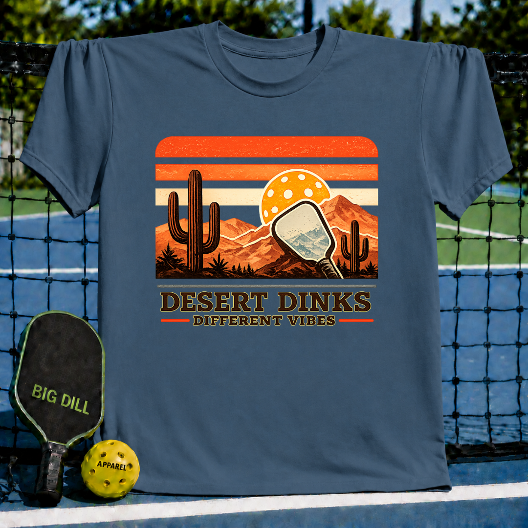 Blue crewneck t-shirt featuring a retro desert sunset graphic with a pickleball paddle, cacti, and Desert Dinks text.