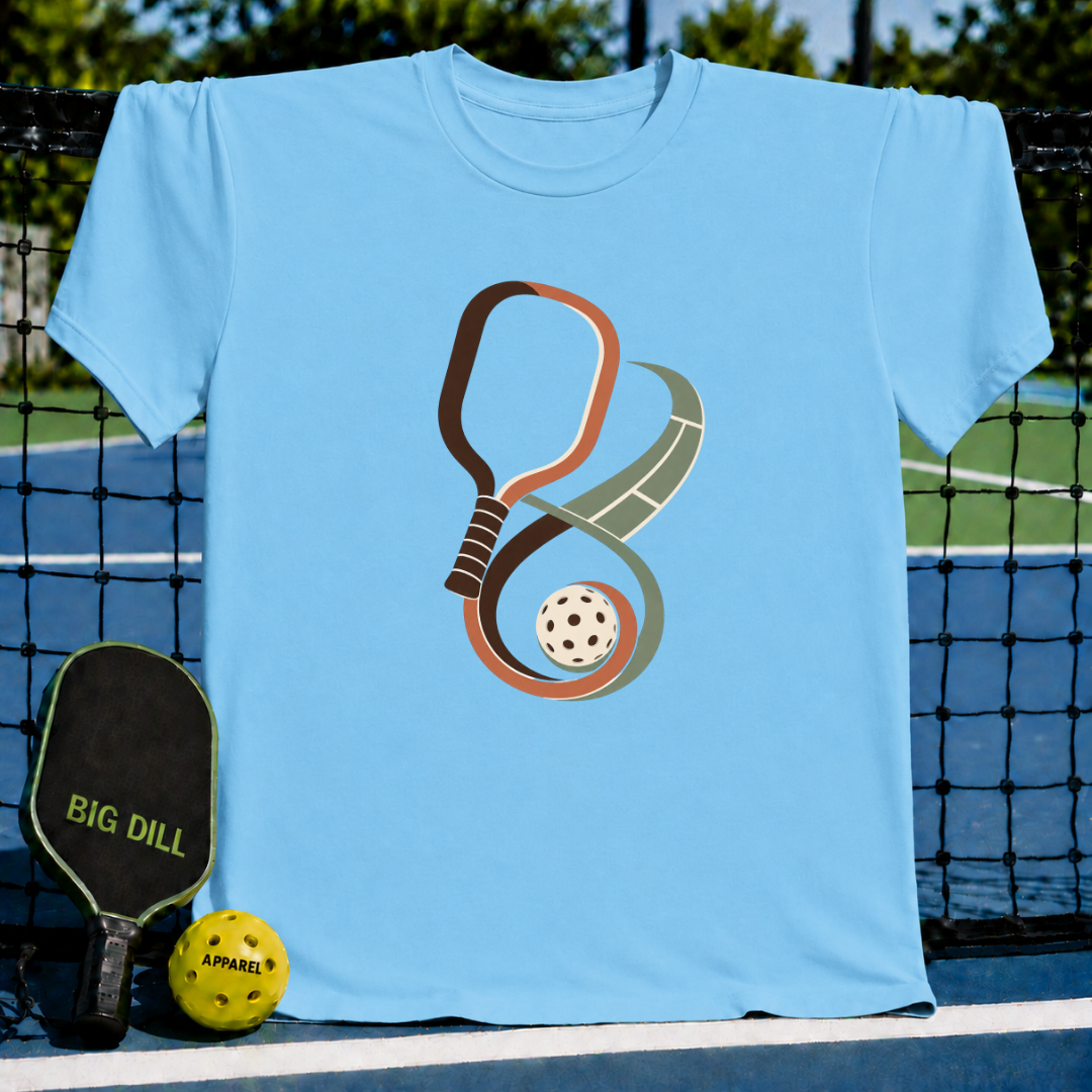 Light blue crewneck t-shirt featuring a brown pickleball paddle and ball forming an infinity symbol design.