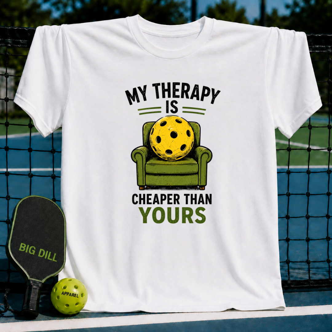 White unisex t-shirt featuring a yellow pickleball sitting in a green armchair with the text My Therapy Is Cheaper Than Yours.