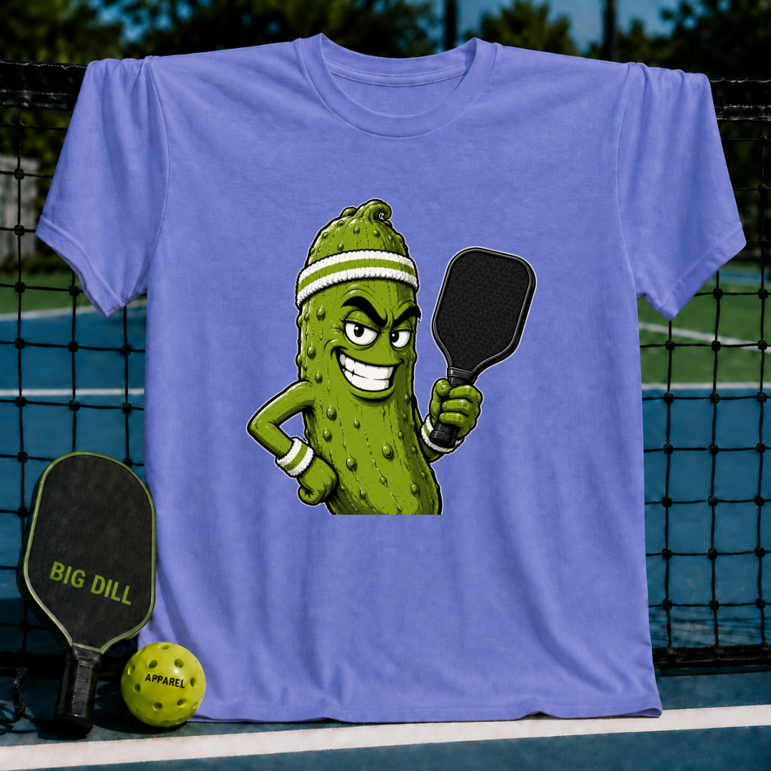 Light blue unisex t-shirt featuring a smirking pickle character with a sweatband and pickleball paddle.