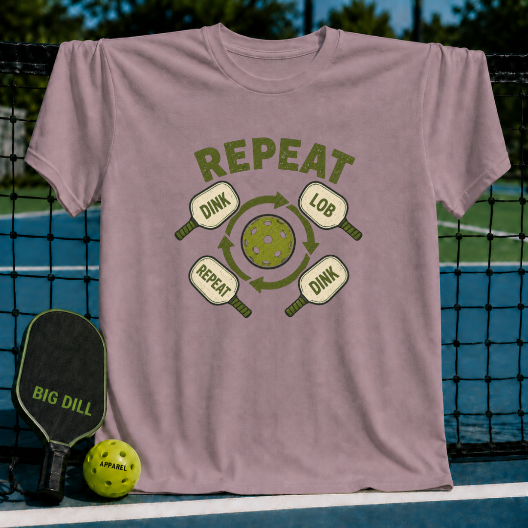 Mauve crewneck t-shirt featuring a green pickleball graphic with the text Dink, Lob, and Repeat on a court background.